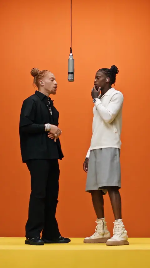 Two rappers in front of an orange background, VimoSwap example video